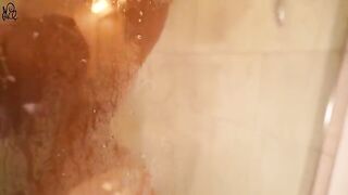 A young girl caresses herself with a big dildo in the shower