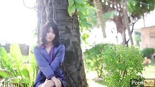 A cute Asian girl masturbates with her favorite toy in the garden