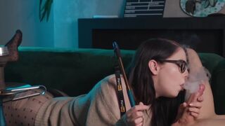 A girl with glasses smokes and sucks cock while getting cunnilingus