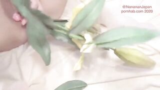 A girl in a floral dress has flowers stuck in her ass