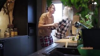 A couple has an intimate moment in the kitchen