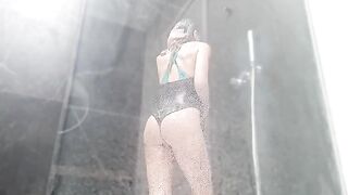 A woman takes a shower and rubs her sweet pussy to make it wet