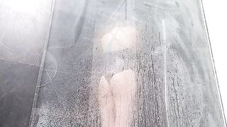 A woman takes a shower and rubs her sweet pussy to make it wet