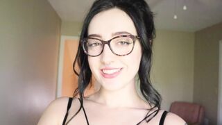 A girl is reading a funny book and she's trying not to cum