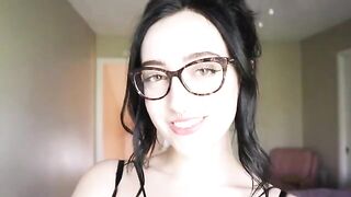 A girl is reading a funny book and she's trying not to cum