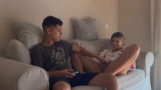 The stepsister is playing a video game and stops when the guy finishes