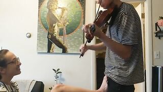 The guy tried to practice violin but was interrupted by his passionate girlfriend