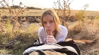 A beautiful Russian blonde has a gentle blowjob in the forest at sunset
