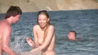 A mature woman sunbathes naked on the sandy beach in HD