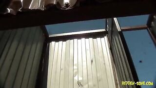 A girl has sex on the beach in a secluded cabin, unaware of being watched