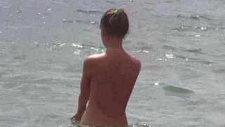 Nudists enjoy each other's company on the naked beach