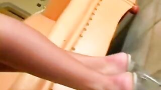 Beautiful woman masturbating on a leather chair, showcasing her erotic allure