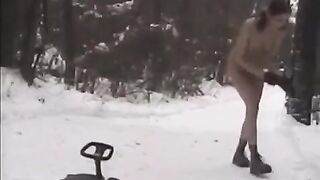 Nude girls have fun with snowballs on the street in winter