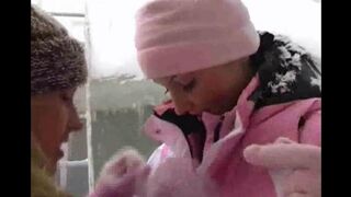 Two girls are having fun on a cold winter day, getting wet