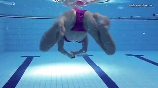 A beautiful naked girl is swimming in the pool, it's very erotic
