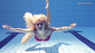 A beautiful naked girl is swimming in the pool, it's very erotic