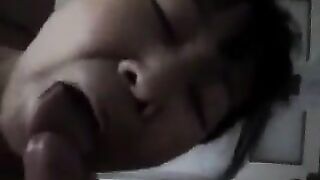 An adult Chinese woman practices her blowjob skills on him