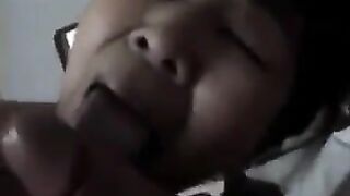 An adult Chinese woman practices her blowjob skills on him