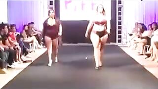 Some fat girls are running on the boardwalk in front of the camera