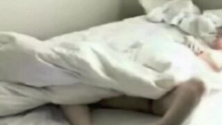 A girl caresses herself on the bed, not knowing there’s a camera