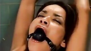 A bald guy fucked a girl with a sex machine using ropes