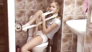 Blonde surprises someone in the public toilet, showcasing youthful energy