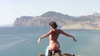 A girl in different poses gets naked on the beautiful beach