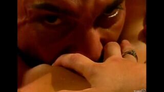 The couple enjoy each other on the couch with passion and tenderness