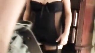 A husband shooting his sexy wife wearing a corset in the bedroom