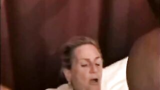A mature woman is being fucked by a black guy