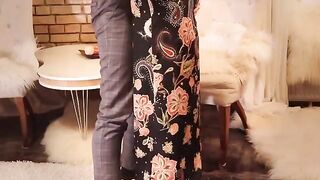 Redhead in long black dress, high heels, and stockings gets fucked