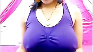 The nipples of an excited brunette push through her T-shirt