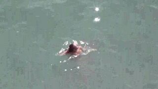 A couple enjoying each other without any clothes on the sea