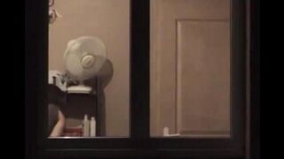 He admires himself in the mirror standing in front of him completely naked