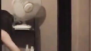 He admires himself in the mirror standing in front of him completely naked