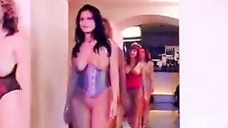 A big-breasted girl is having fun with many boys on the couch