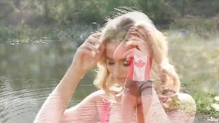 A blonde girl was indulging herself on the shores of the lake