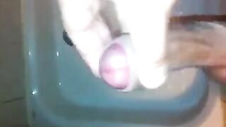 The kid masturbates his dick under the shower jet