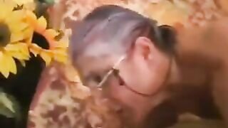 A mature gray-haired woman in black stockings was fucked by a man