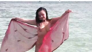 A hot girl is having fun with her body in the sea