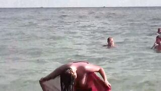 A hot girl is having fun with her body in the sea