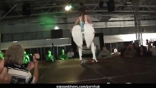 A girl is learning to striptease on a pole