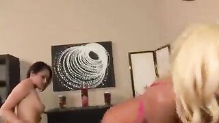 Frustrated lesbians grind each other through their skirts with a dildo