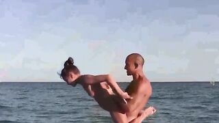 Naked beauties are showing their skills in acrobatics on the beach