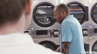 A girl is doing her laundry when a neighbor joins her to have some fun