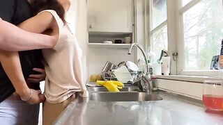 A busty woman is being fucked in the kitchen by her husband