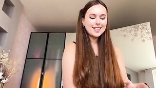 A sexy brunette in lingerie is doing a great blowjob with a condom