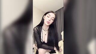 A girl in black plays with her pussy and a dildo, embodying the goth vibe