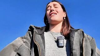 A petite teen bares all on the public beach to masturbate
