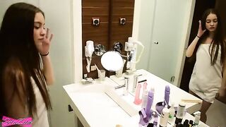 A young girl is having fun in the shower and on the bed with someone